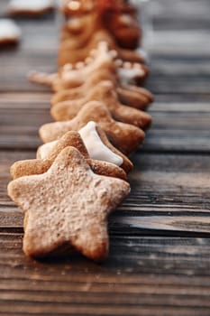 Cookies laying down in a row. Christmas background with holiday decoration.