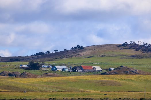 Historic farm and ranch buildings in rolling green hills on sunny day. High quality photo