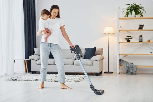 Domestic life. Mother with her little daughter is indoors at home together.