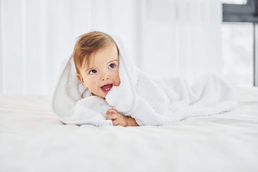 Positive emotions. Cute little baby is indoors in the domestic room.
