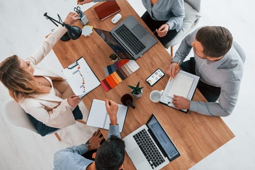 Top view. Group of business people that working on the project in the office.