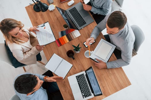 Top view. Group of business people that working on the project in the office.