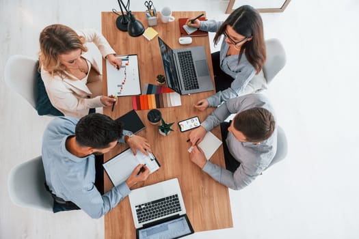 Top view. Group of business people that working on the project in the office.