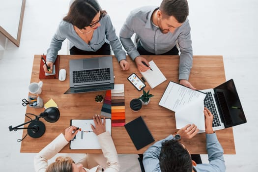 Having conversation. Group of business people that working on the project in the office.