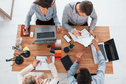 Having conversation. Group of business people that working on the project in the office.
