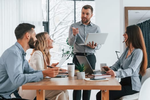 Using brainstorming technique. Group of business people that working on the project in the office.