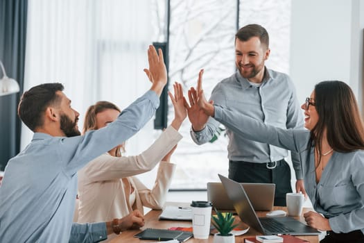 Using brainstorming technique. Group of business people that working on the project in the office.