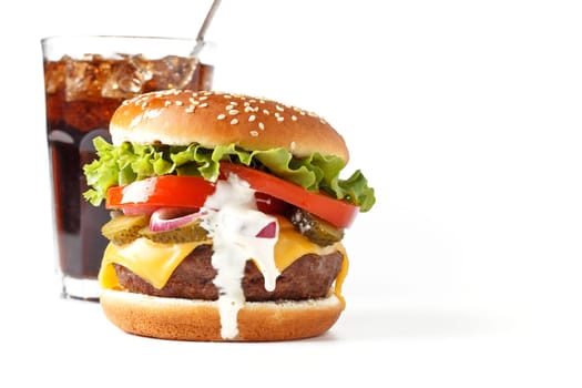 Classic cheeseburger with fizzy drink isolated on white background. copy space