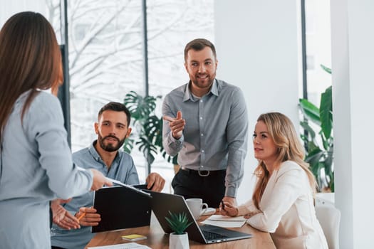 Sharing some ideas. Group of business people that working on the project in the office.