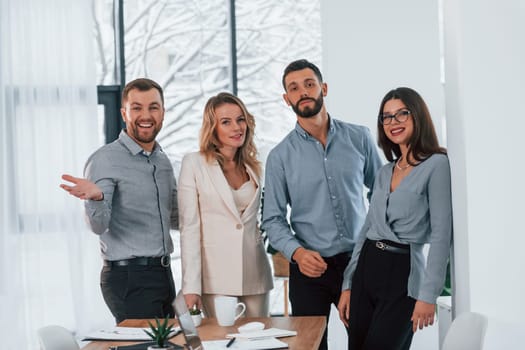 Standing together. Group of business people that working on the project in the office.