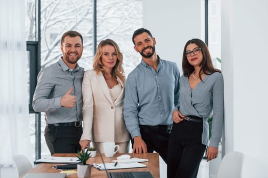 Standing together. Group of business people that working on the project in the office.