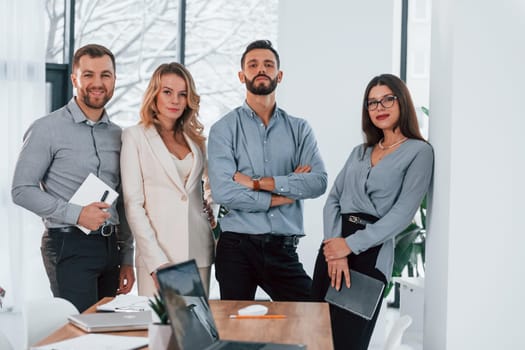 Standing together. Group of business people that working on the project in the office.