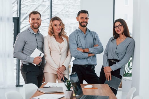 Standing and posing. Group of business people that working on the project in the office.
