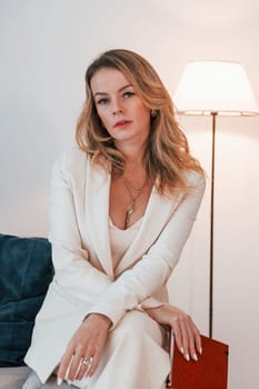 Business woman in formal clothes is indoors posing for the camera.