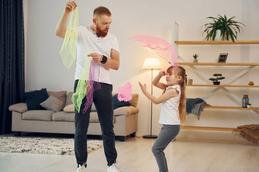 Having fun. Father with his little daughter is at home together.