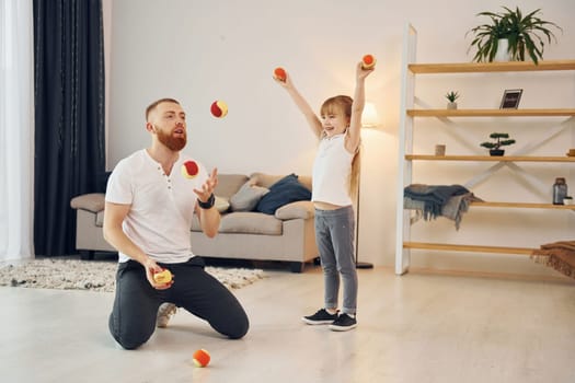 Father with his little daughter is at home together.