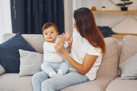 Conception of parenting. Mother with her little daughter is at home together.