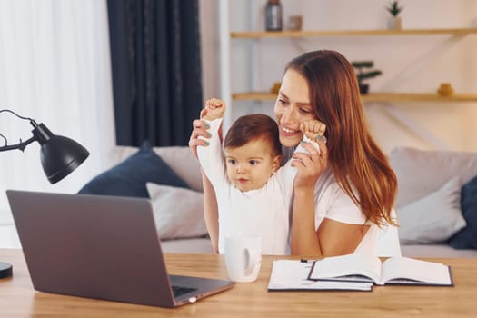 Mother with her little daughter is at home together.