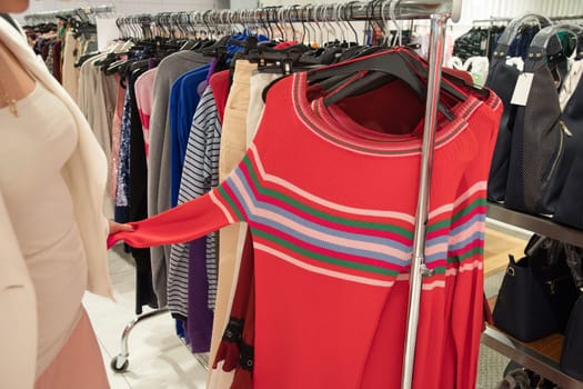 girl in the store chooses on a hanger pink blouse, color millennial, beauty fashion clothes, High quality photo