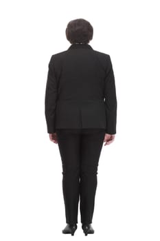 rear view. Mature business woman in a black pantsuit . isolated on a white background.