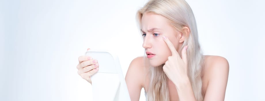 Acne problem troubling closeup personable worried woman with natural beauty skin checking her face squeezing pimple spots in isolated background. Copyspace for blemish skincare treatment problem.