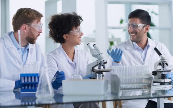 Team of Scientists Working Using Microscope, Analysing Microbiology Samples