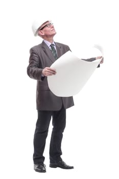 in full growth. business man in a protective helmet with drawings. isolated on a white background.