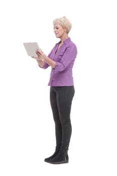 in full growth. smiling mature woman with a digital tablet . isolated on a white background.