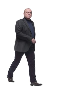 in full growth. a man in a business suit striding forward. isolated on a white background
