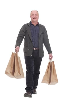 in full growth. cheerful casual man with shopping bags .isolated on a white background.