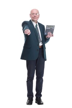 in full growth. serious business man pointing at the calculator screen. isolated on a white background.