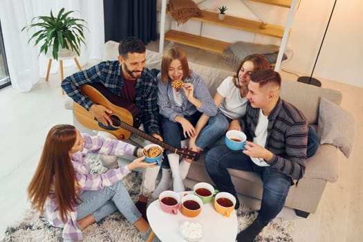 Weekend rest. Group of friends have party indoors together.
