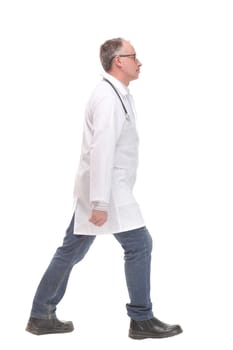 Middle age male doctor walking away and look at camera isolated on white. Concept of health care