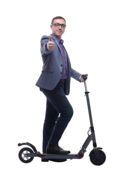 Pleasant smiling man wearing jeans and glasses riding a kick scooter