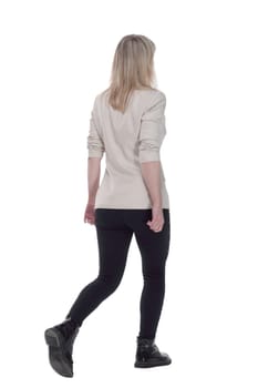 rear view. woman in a white jacket striding confidently away . isolated on a white background.