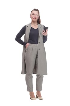in full growth. attractive woman with a smartphone .isolated on a white background.