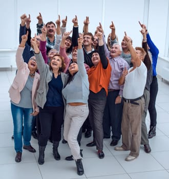 a group of elderly people raised their hands up