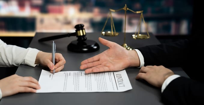 Lawyer signing contract, professional lawyer in law firm library drafting legal document or contract agreement ensuring lawful protection for client's dispute as fairness advocate concept. Equilibrium