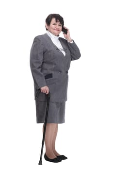 in full growth. casual elderly woman with a mobile phone. isolated on a white background.