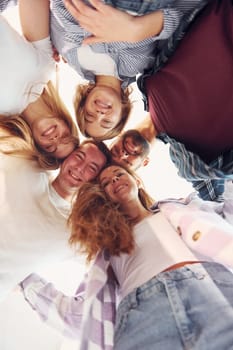 Looking down. Group of friends standing together.