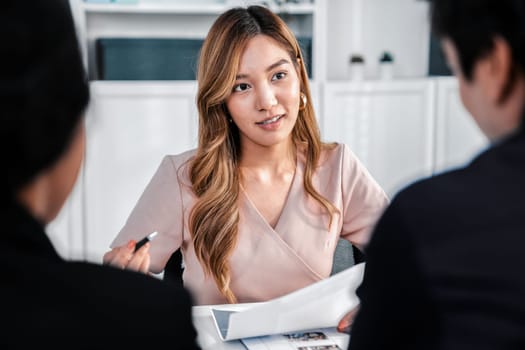 A young female asian candidate tries to impress her interviewer by being competent. International company, multicultural environment in workplace.