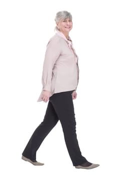 side view. elderly lady confidently striding forward. isolated on a white background.