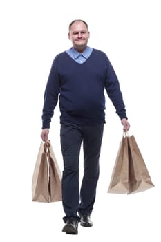 in full growth. casual mature man with shopping bags. isolated on a white background.