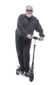 in full growth. elderly man standing on electric scooter. isolated on a white background
