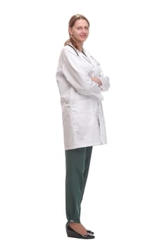 Side view of young female doctor or nurse standing over white background thoughtfully and looking forward.