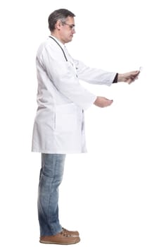 in full growth. qualified doctor looking at an x-ray. isolated on a white background.
