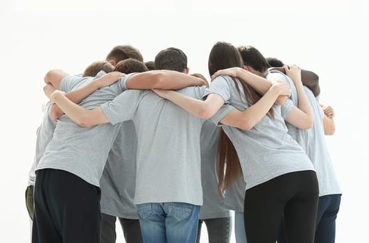 group of young people standing in a circle and hugging each other. isolated on white