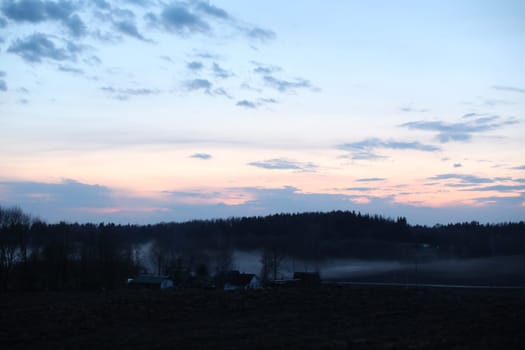 Glorious sunset over grassy rural landscape