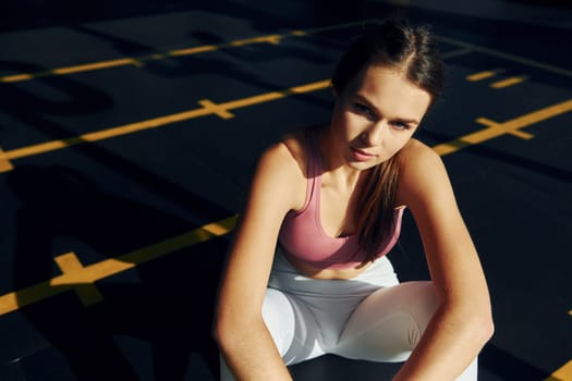 Natural lighting. Beautiful young woman with slim body type is in the gym.