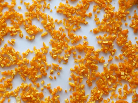 finely chopped orange peels on white table for food background.